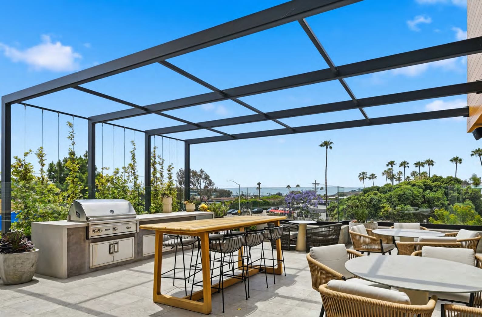 Covered outdoor deck with BBQ and coastal views